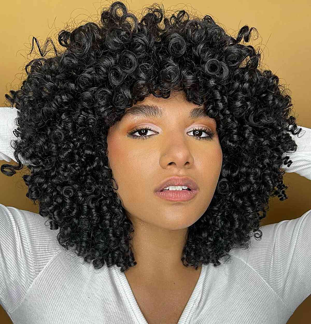 Curly Long Bob with Bangs for Thick Hair and Oval Face Shapes