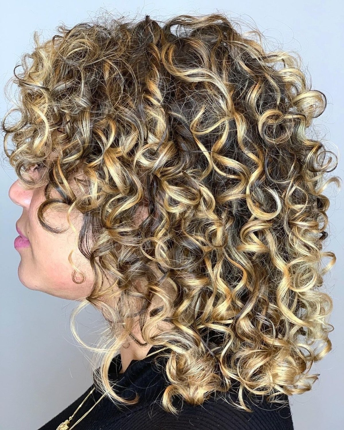 Curly medium brown hair with bright blonde highlights