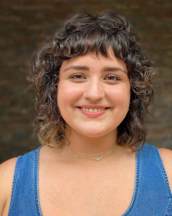 A curly mullet with short bangs