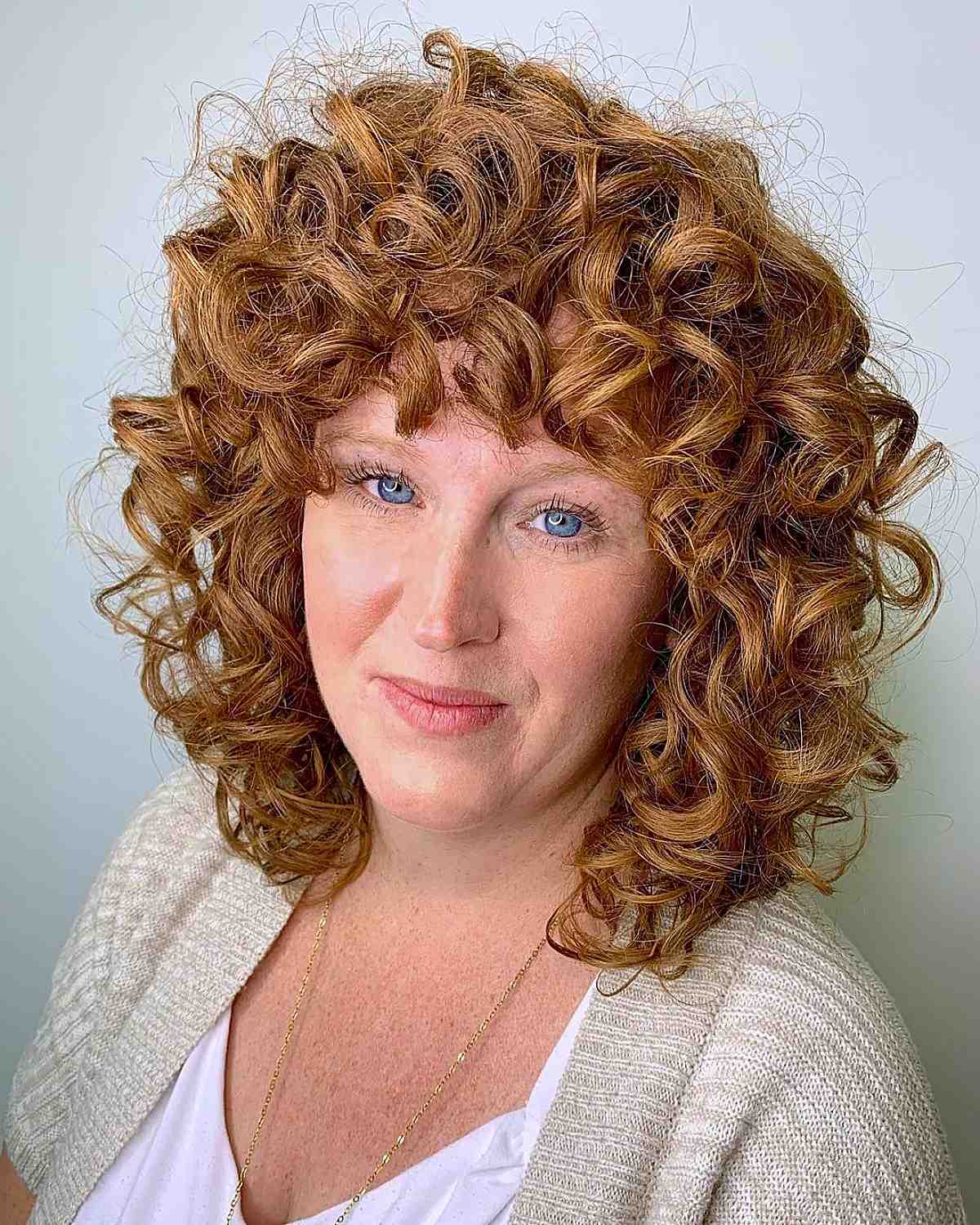 curly natural redhead with bangs