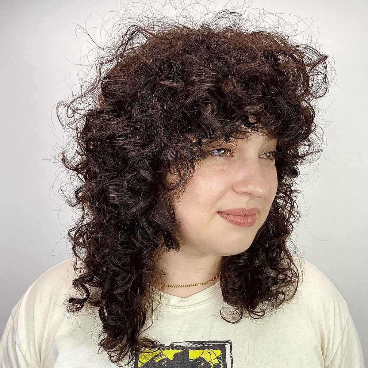 curly shag with bangs for round face shape