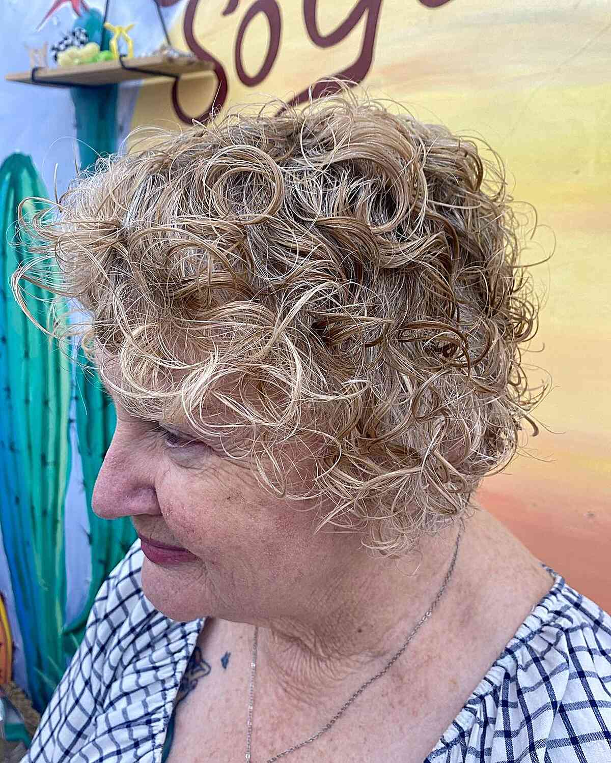 Curly Short Jaw-Length Hair with Dimensional Blonde Color on 60-Year-Old Ladies