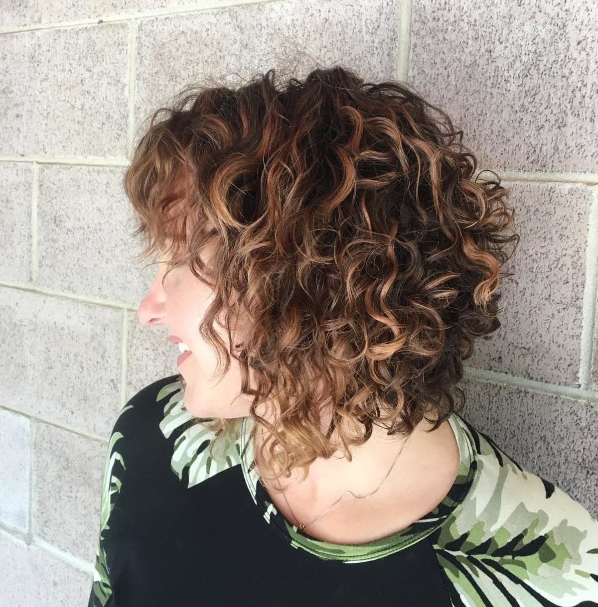 Curly stacked bob with bangs