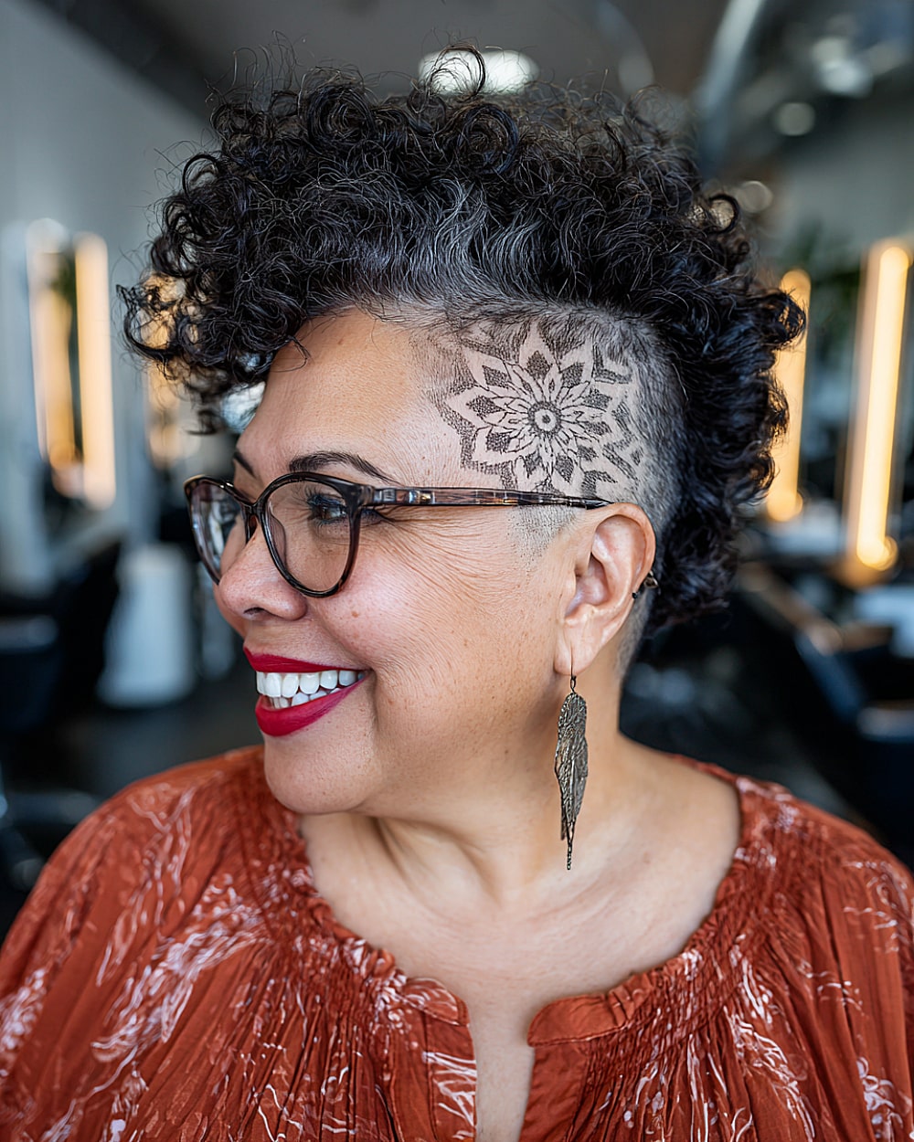 Curly undercut with shaved design and voluminous top curls