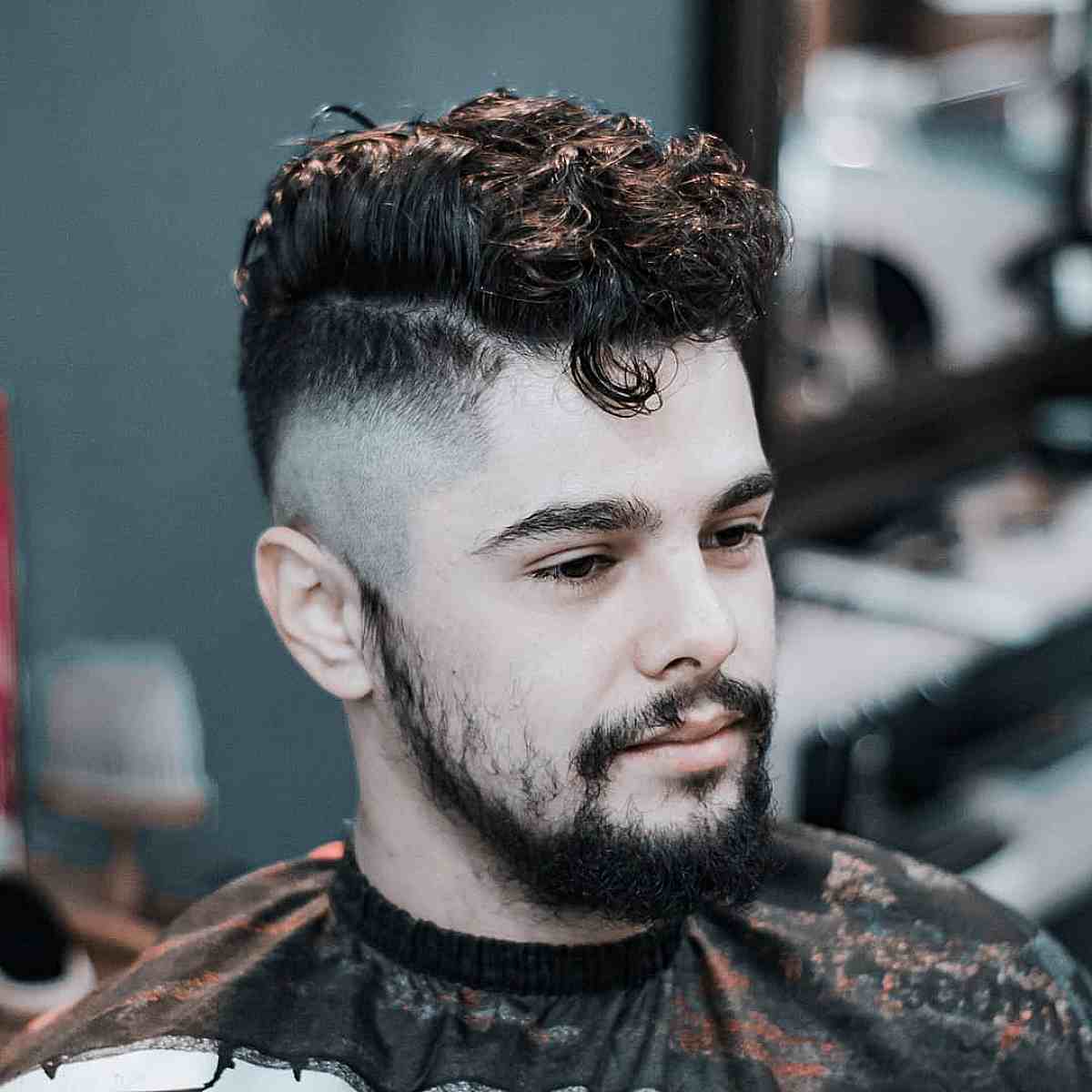 Curly undercut with short pompadour for males
