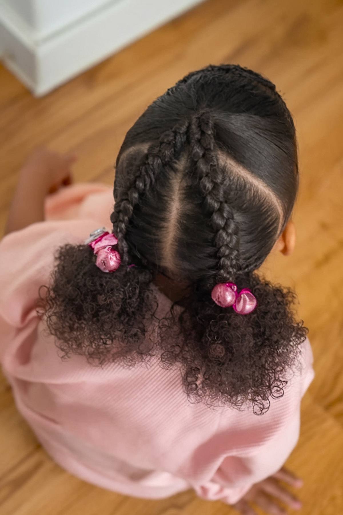 Toddler hairstyle with two afro puffs and bangs