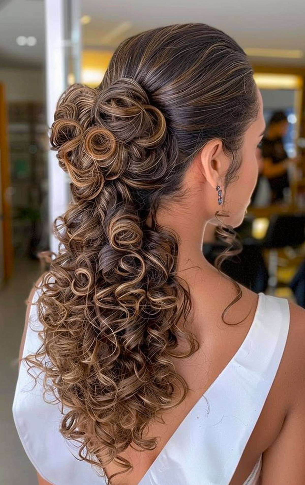 Cute curly hairstyle for formal occasion with bun and cascading ponytail