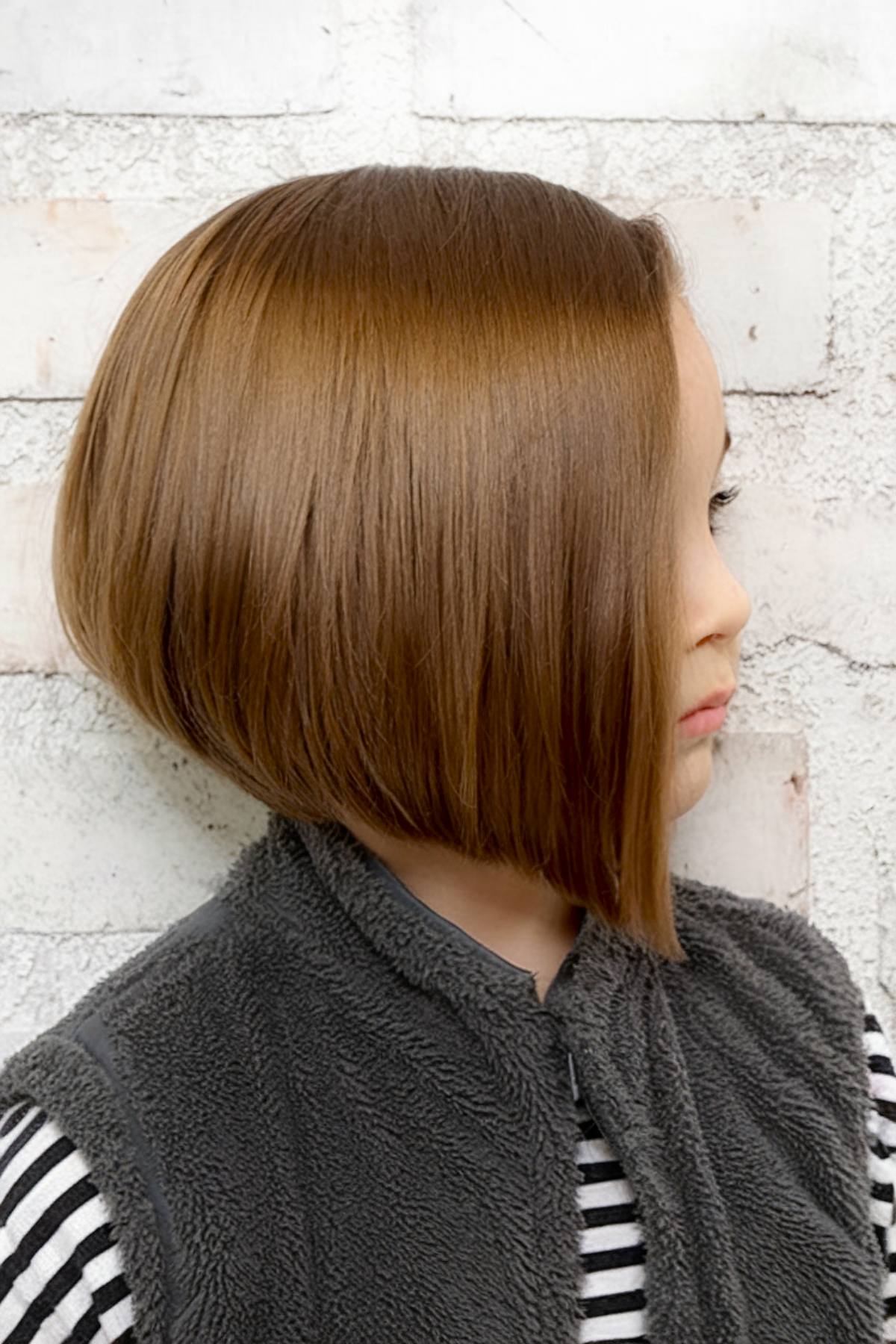 Angled bob haircut for kids with soft framing