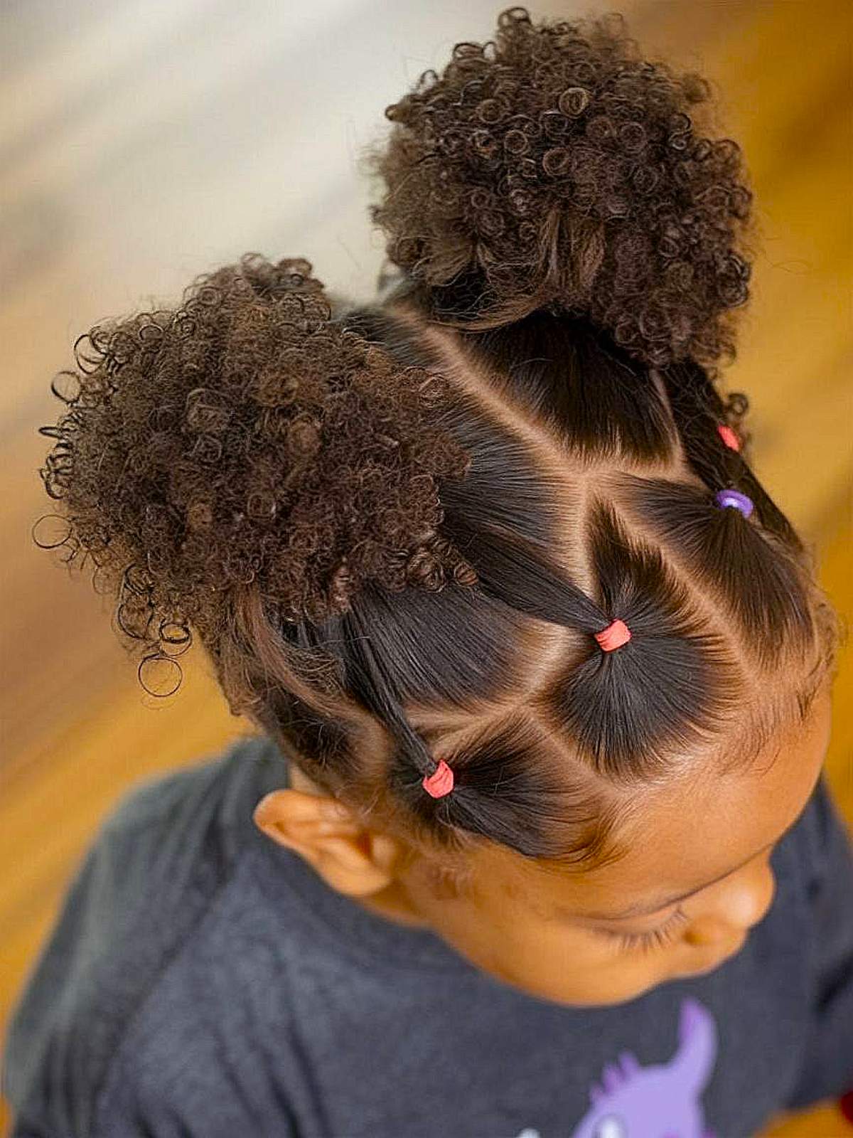 Curly toddler hairstyle with ponytail puffs