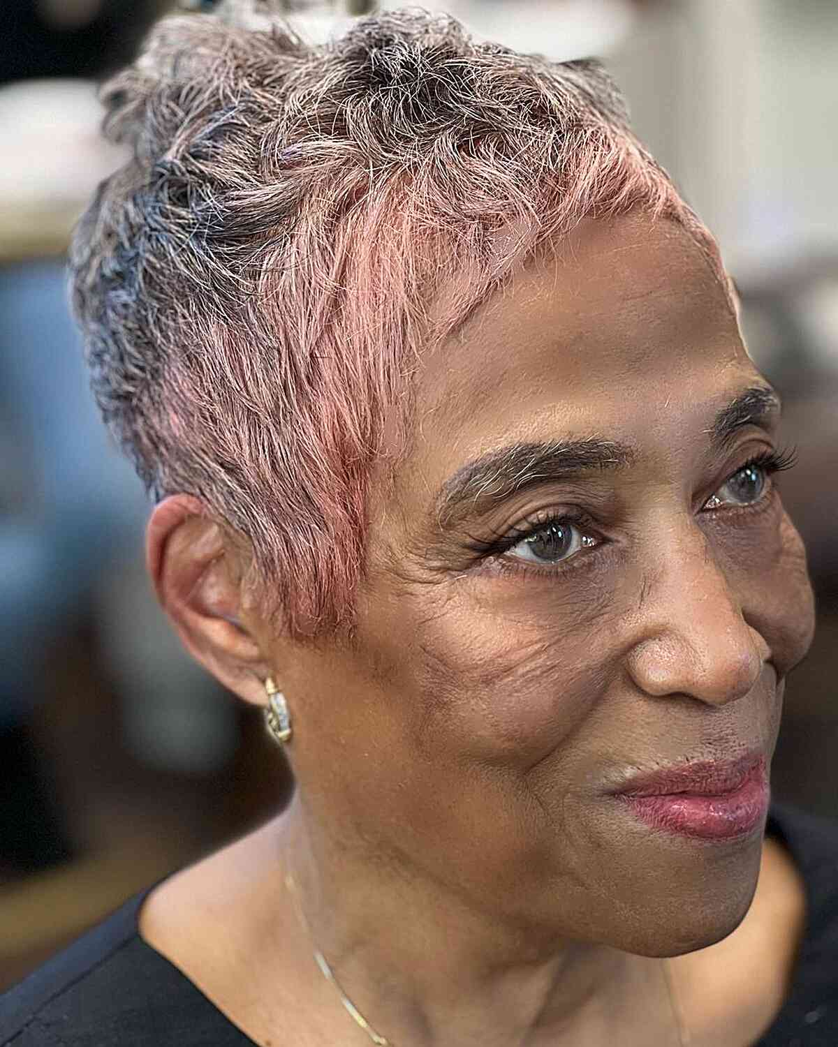 Cute Pixie Cut with Pink Highlights for older Black women with choppy fringe