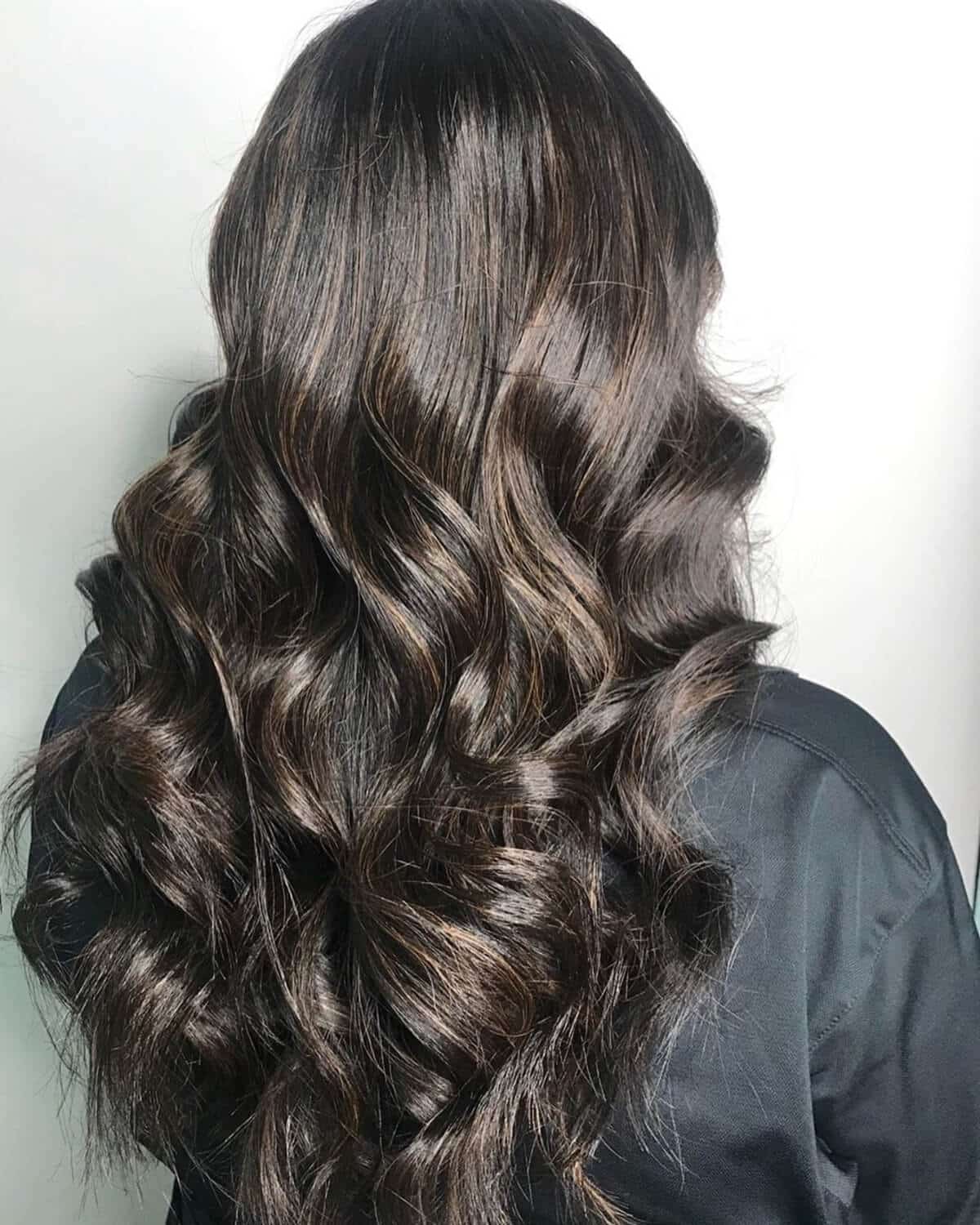 dark brown hair with subtle caramel highlights