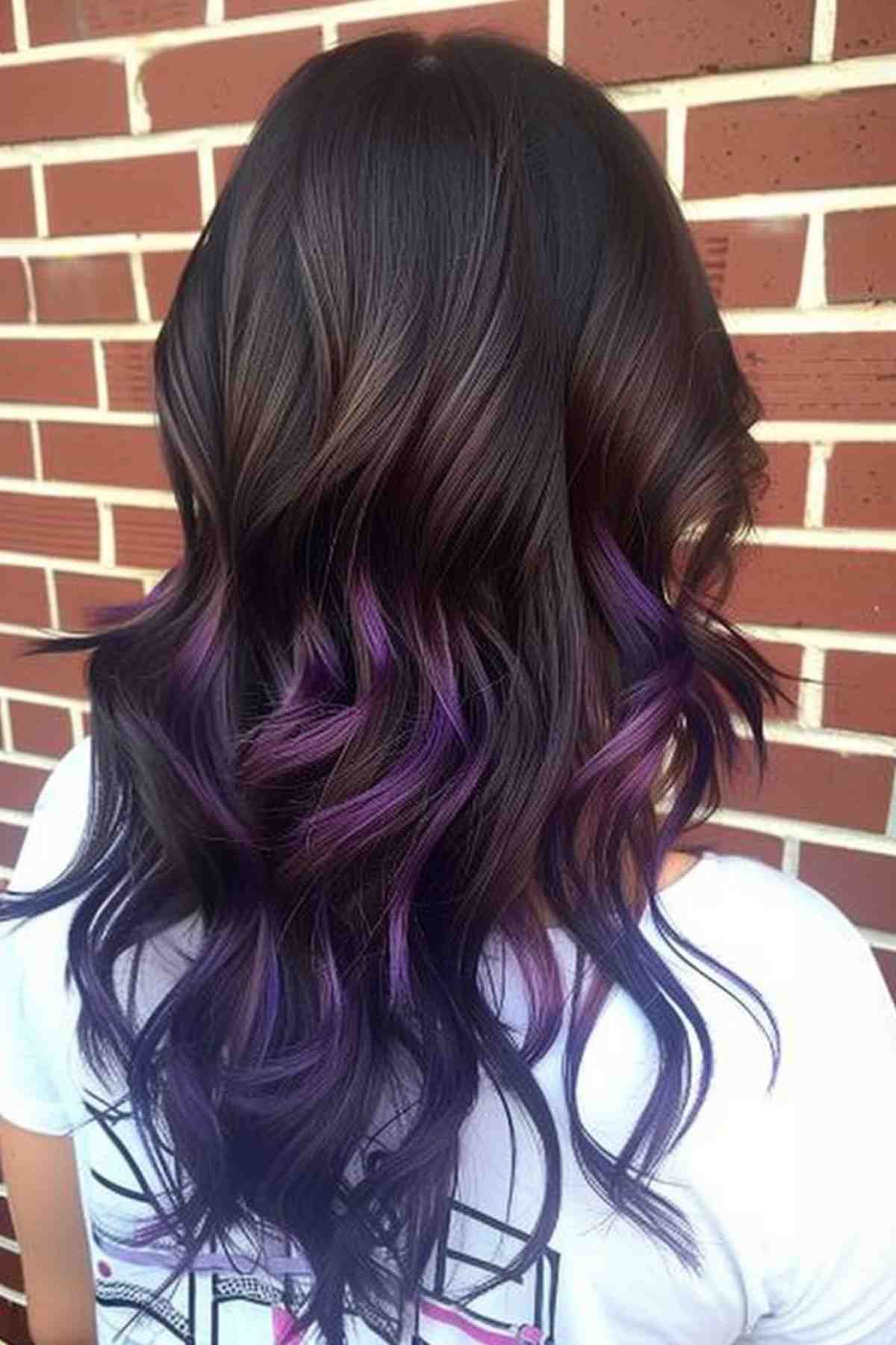 Medium-length wavy hair transitioning from dark brown roots to rich purple ombre ends.