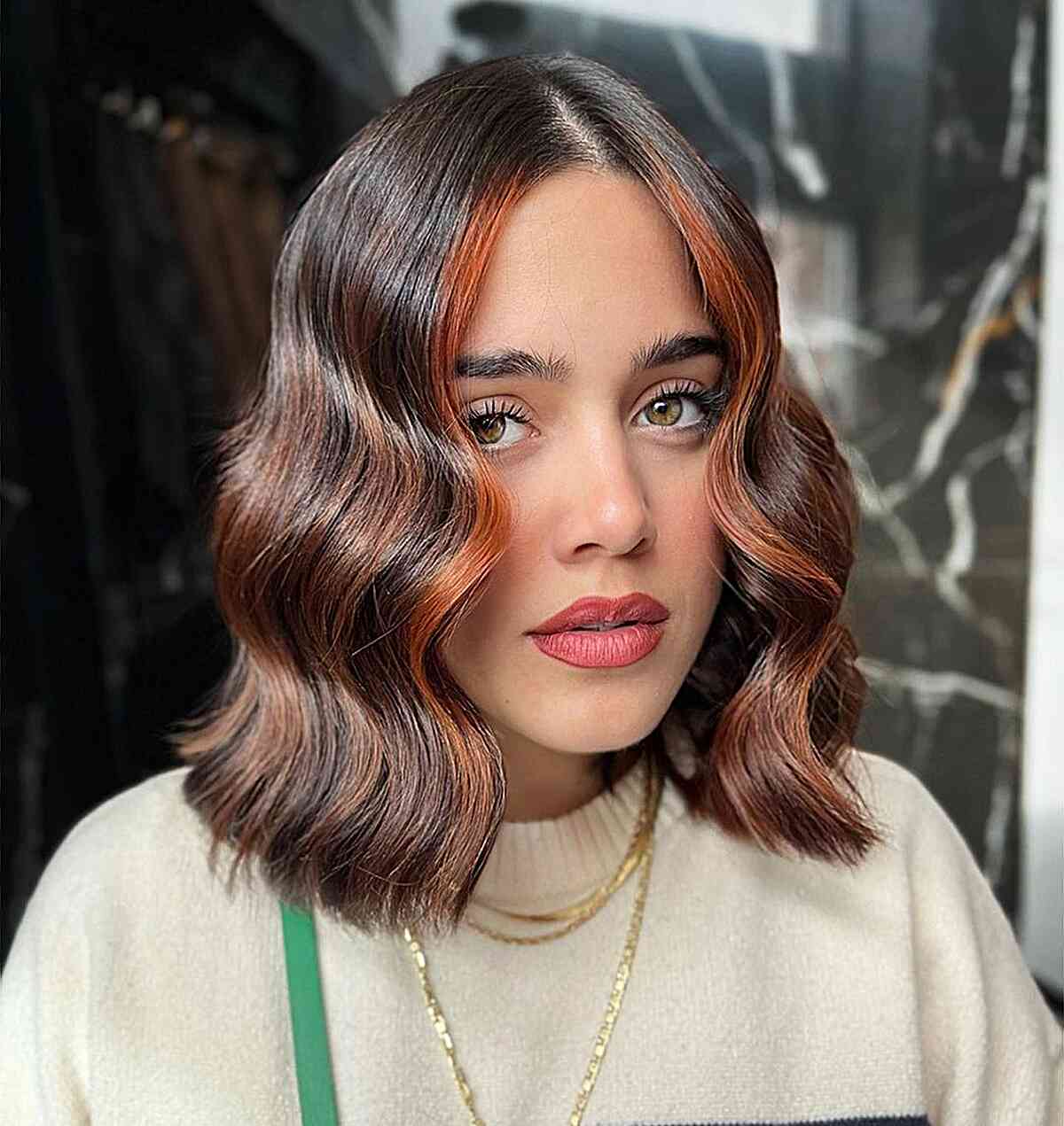 Dark Brunette with Hazelnut Highlighted Tones on women with a long bob haircut