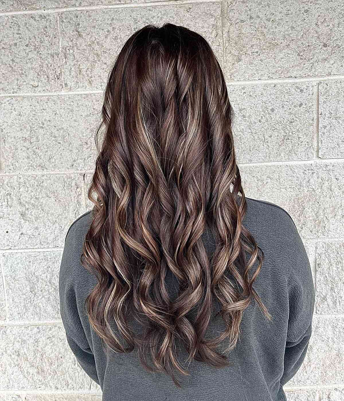 Dark Brunette with Subtle Partial Highlights for Long Wavy Hair