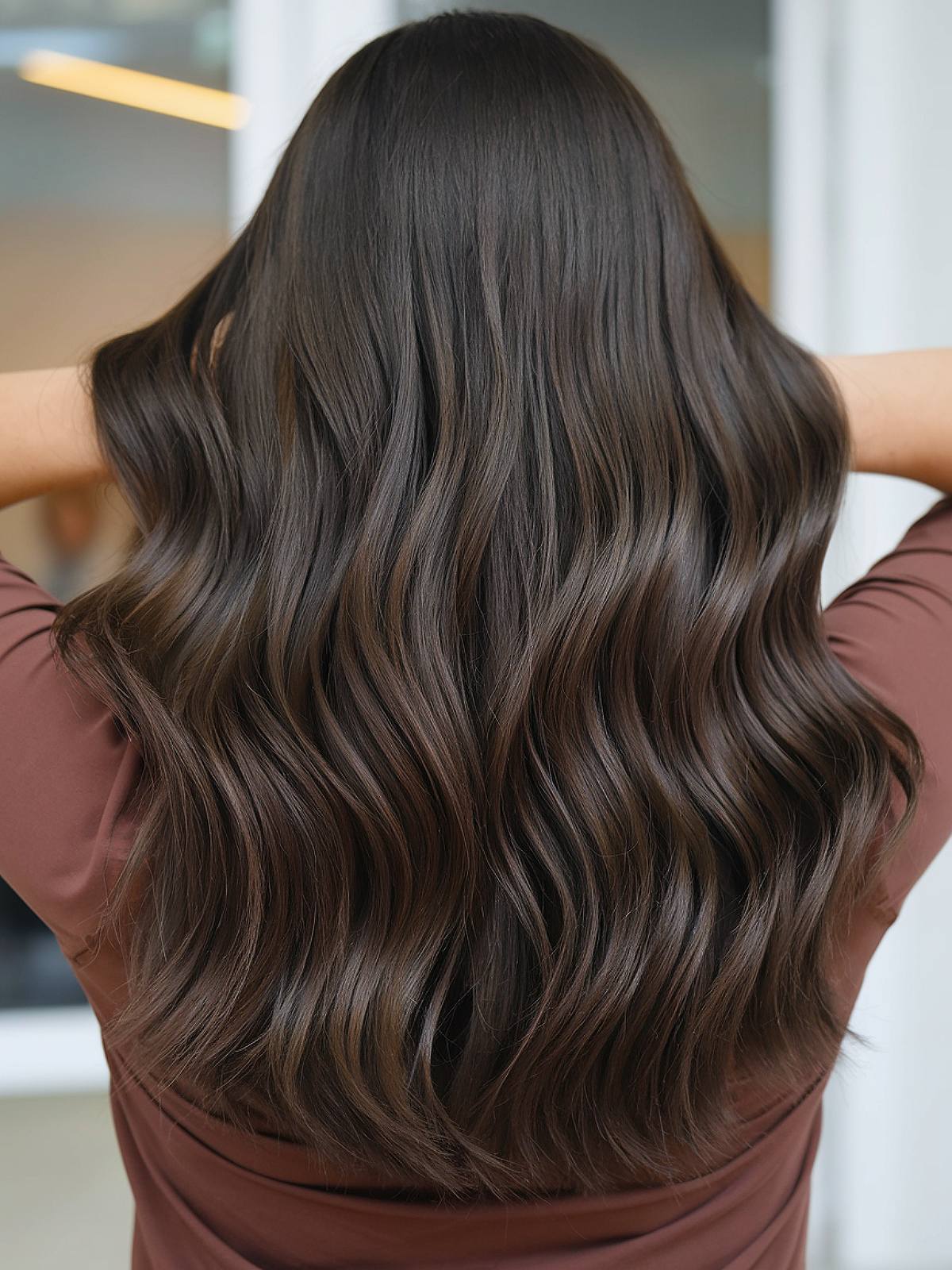 Dark chocolate brown hair with soft waves