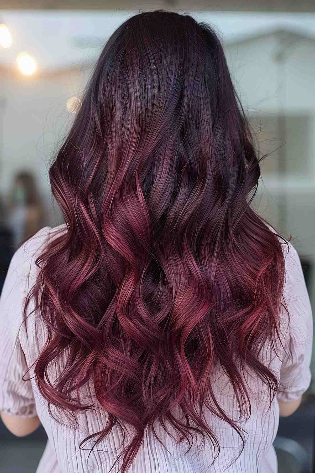 Dark chocolate to cherry ombre on long wavy hair.