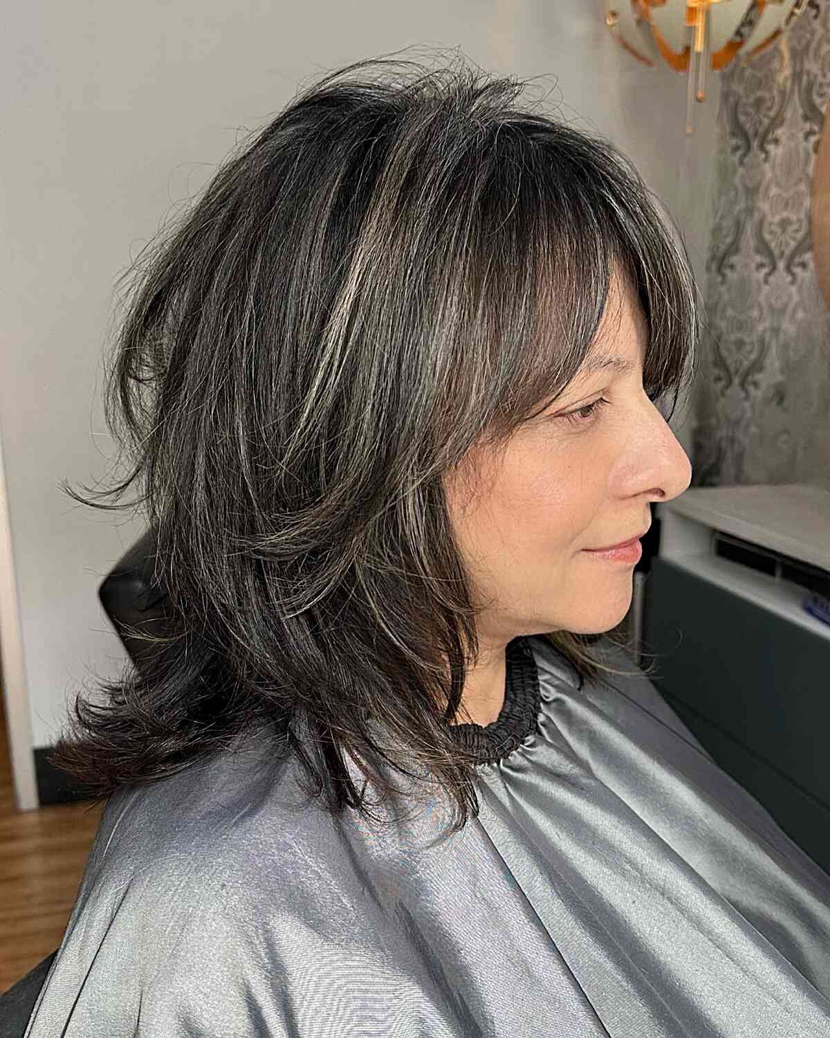Shoulder-Length Dark Layered Hair with Subtle Silver Grey Blended Strands