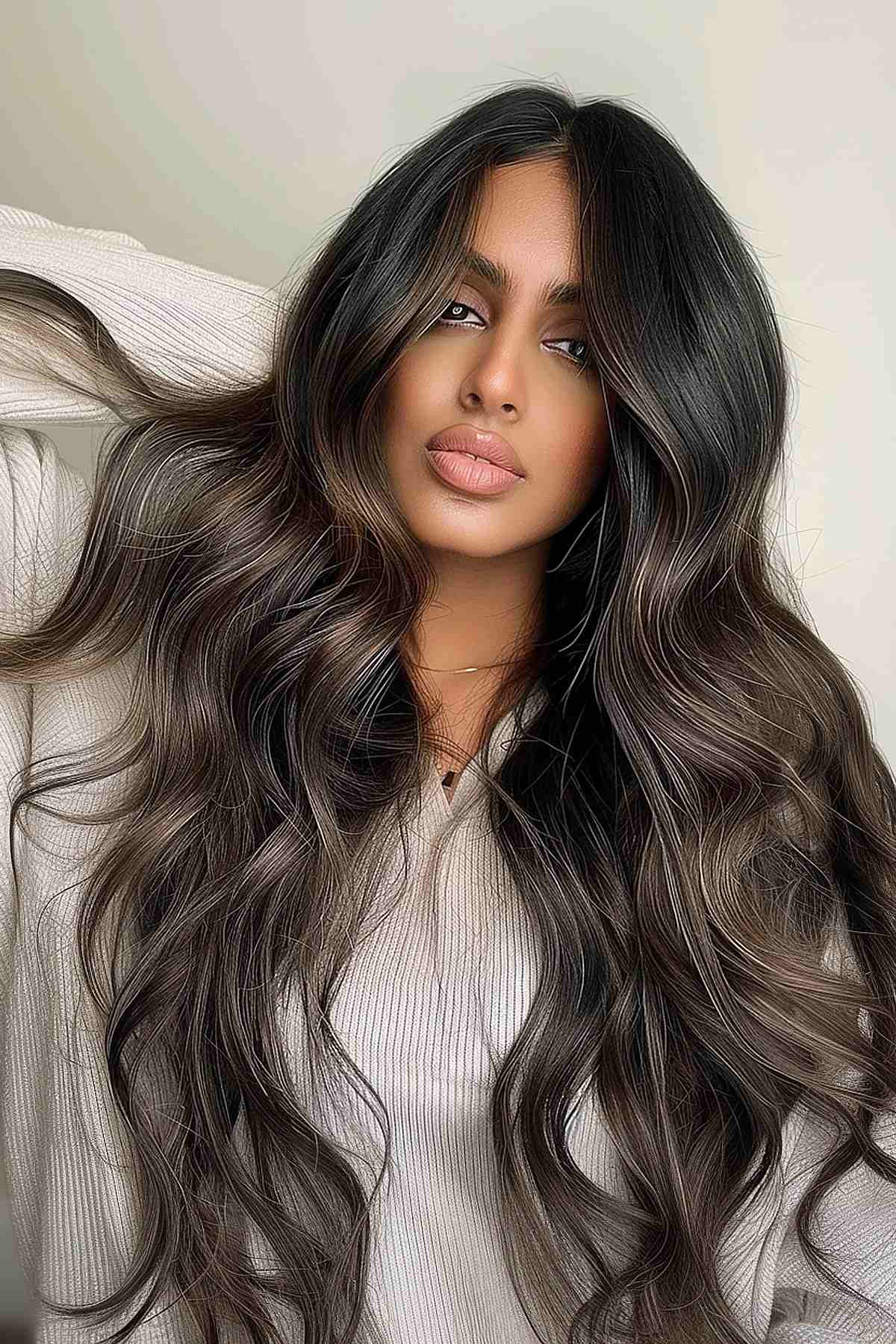 Voluminous dark mushroom brown hair styled in soft waves, enriching the rich, warm hues perfect for medium to dark complexions.
