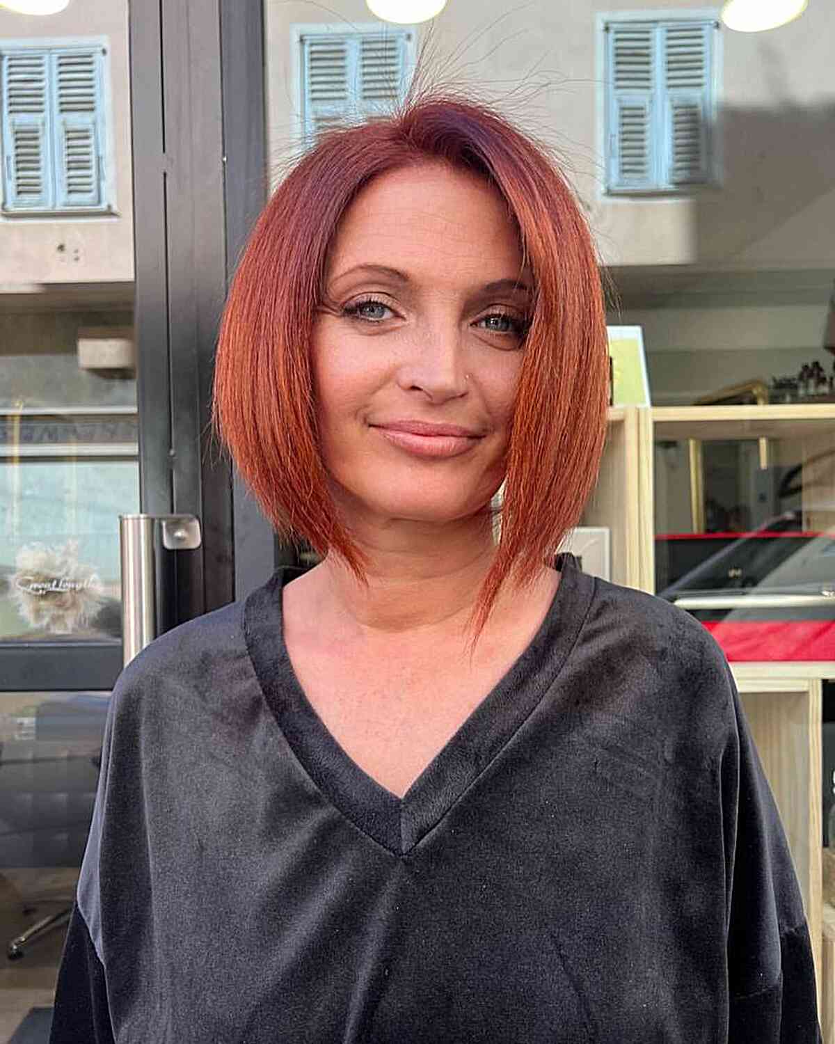 Dark Red Slightly asymmetrical A-Line Bob Cut with a Side Part for a woman over 40