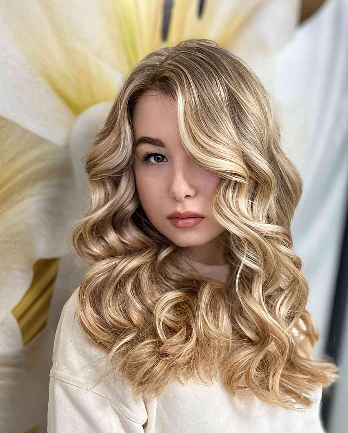 Dark Rooted Blonde Balayage Curled Hairstyle with a side part