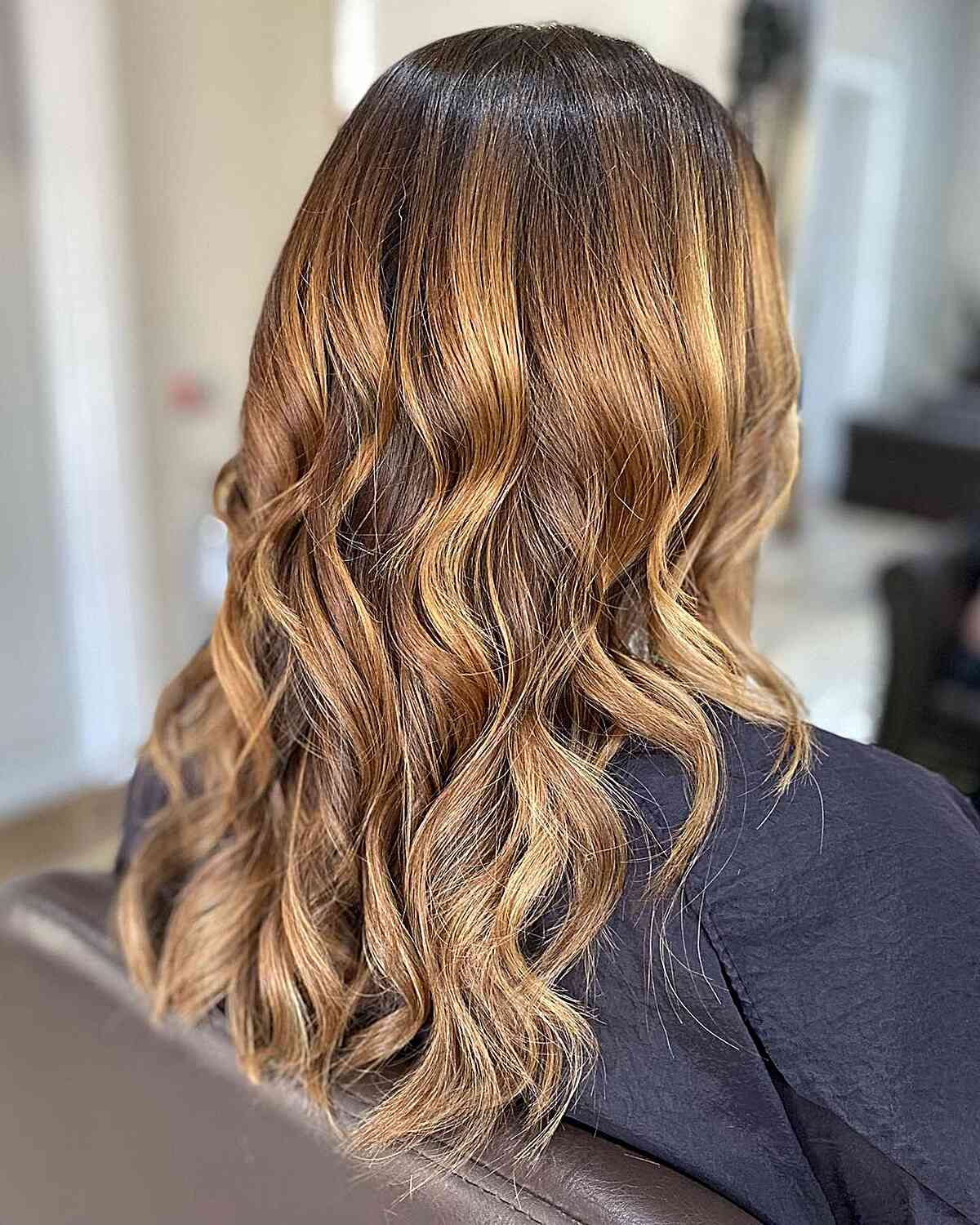Dark-Rooted Caramel Bronde Ombre Hair Highlights on Medium Cut with Loose Curls