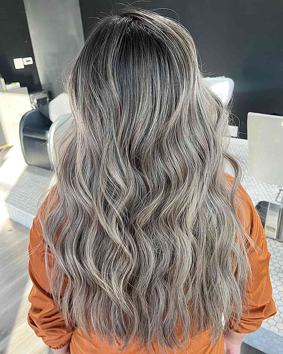 Dark-Rooted Cool Ashy Blonde Tone for Long Wavy Hair