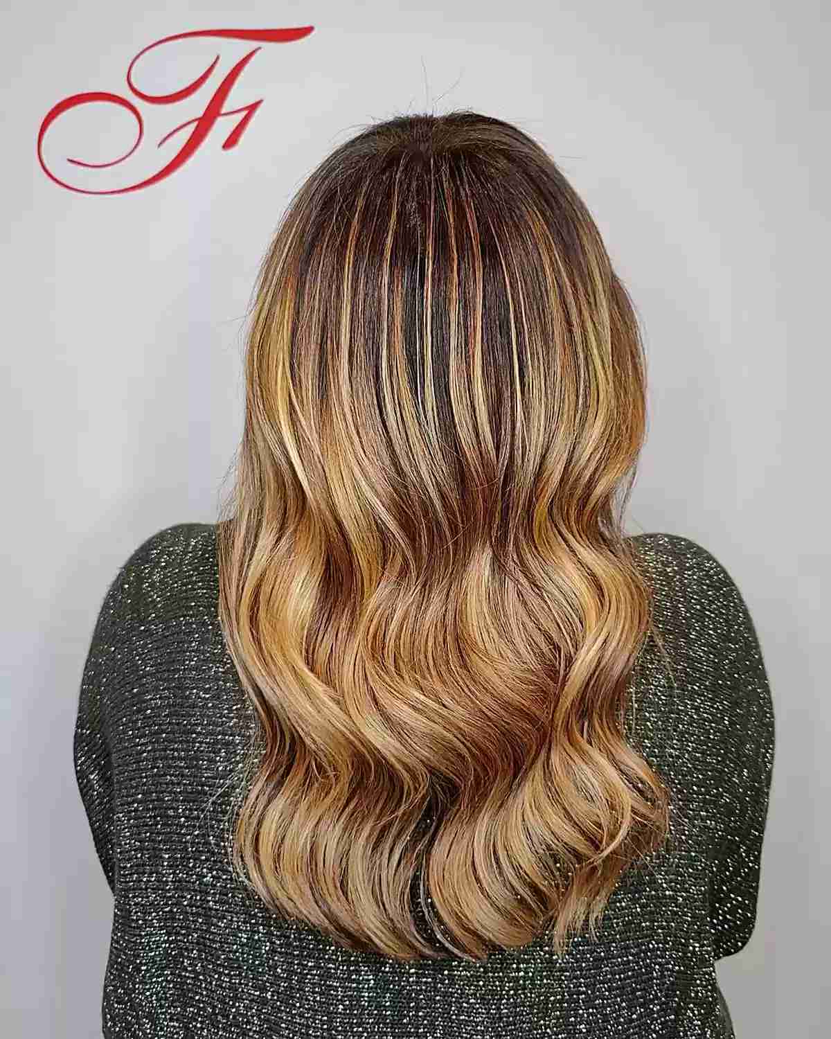 Dark-Rooted Golden Blonde with Copper Tones on Medium-Long Haircut