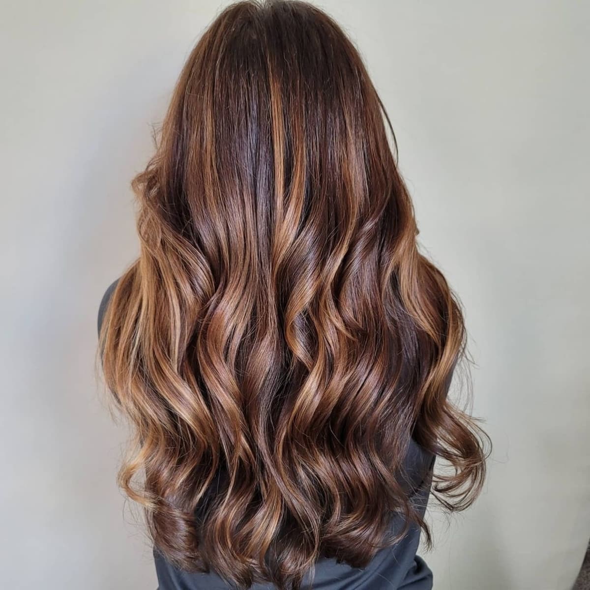 Deep chestnut hair with blonde accents
