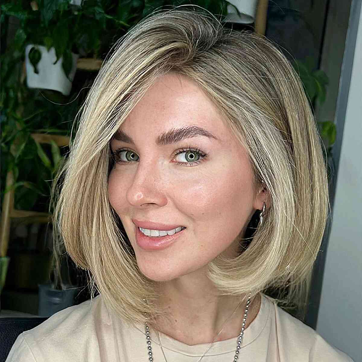 Deep Side Part Straight Bob with blonde highlights and dark roots