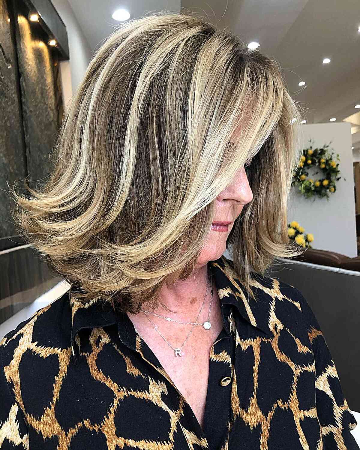Shoulder-Length Dimensional Blonde-Brown Hair with Feathered Ends for Older Women Over Sixty