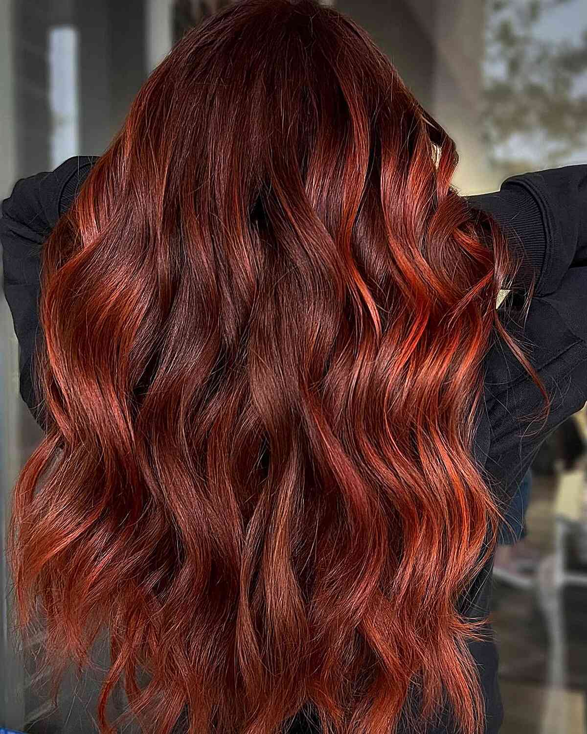 Dimensional Brick Red Balayage on long wavy hair for women