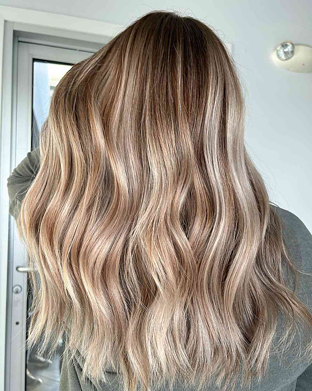 Dimensional Bronde Color Melt with Long Balayage Chunky Waves and Choppy Ends