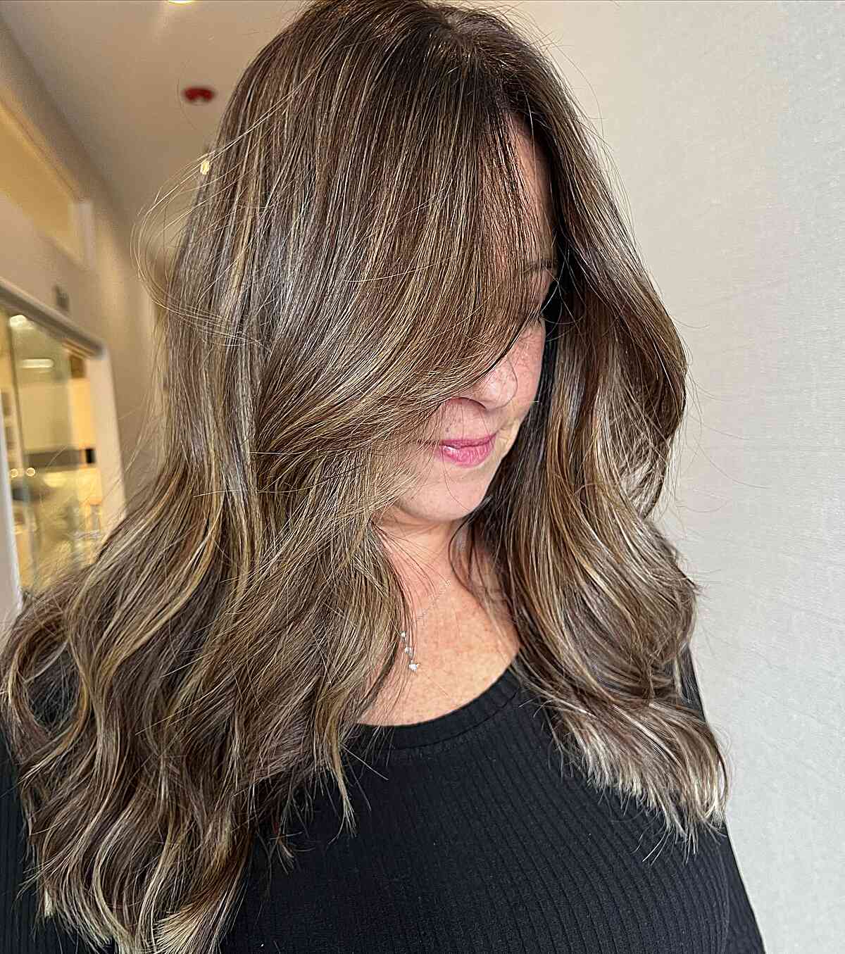 Dimensional Golden Brunette with Long Waves for 60-year-old Ladies