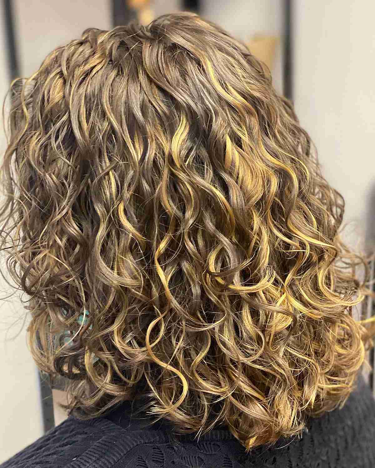 Dimensional Light Brown and Blonde Balayage on Loose Curls