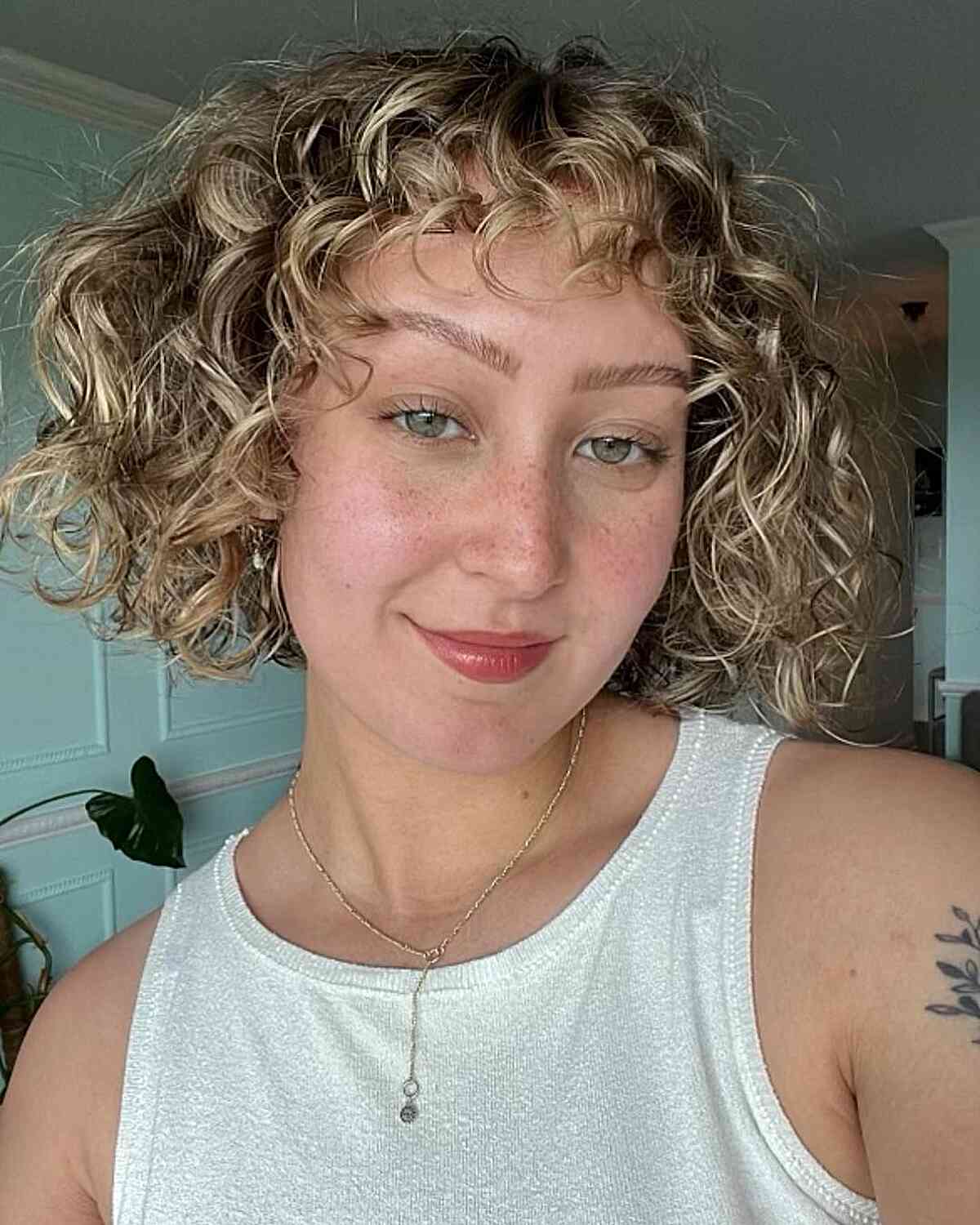 Dirty Blonde Balayage Jaw-Length Mini Curly Bob with Short Piece-y Bangs