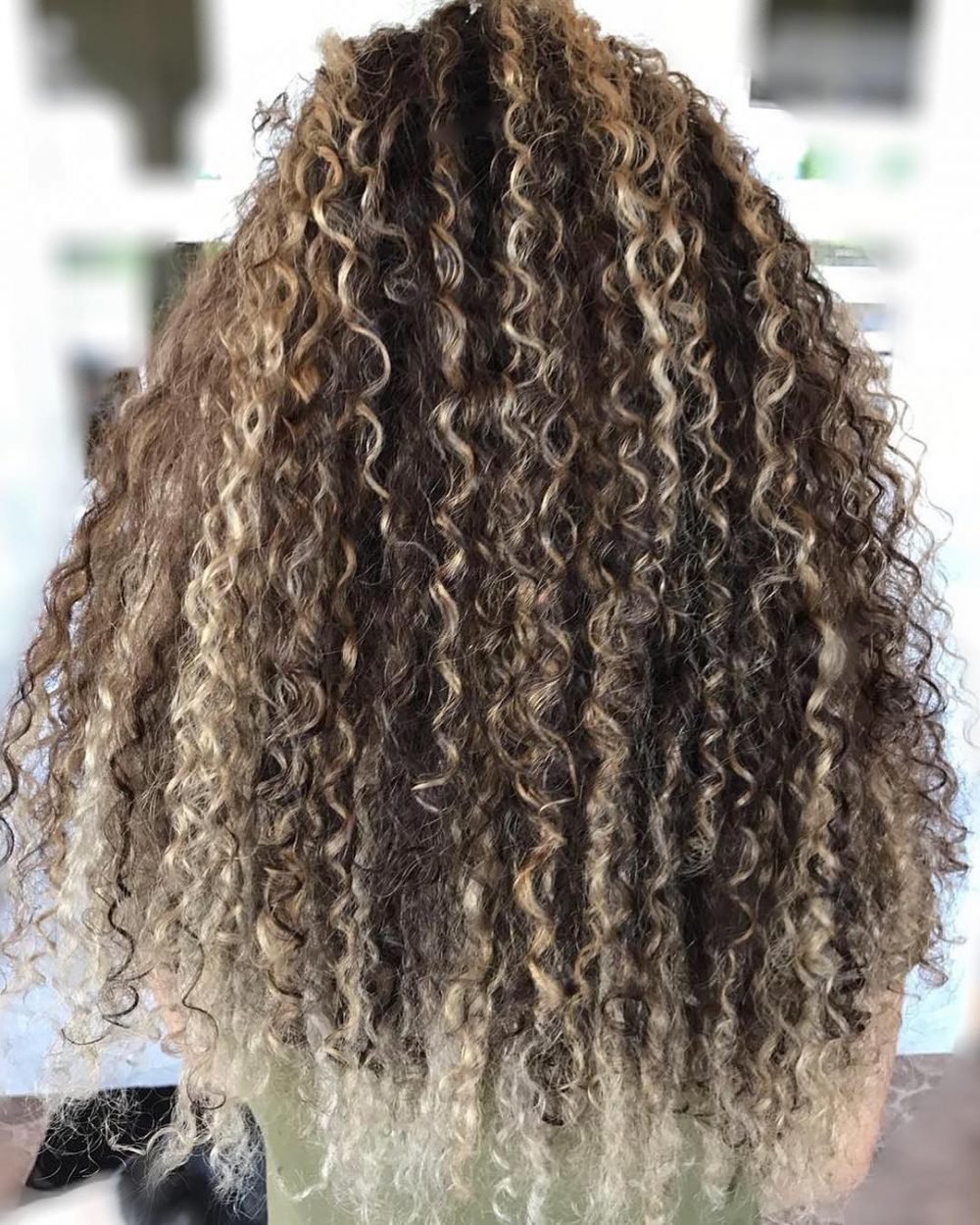 Dirty Blonde Balayage Highlights on Curly Hair