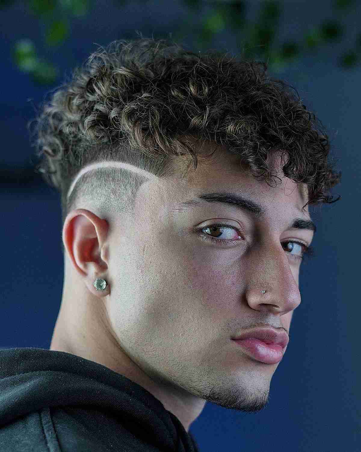 Disconnected Curly Cut with a Curved Razor Line for Men