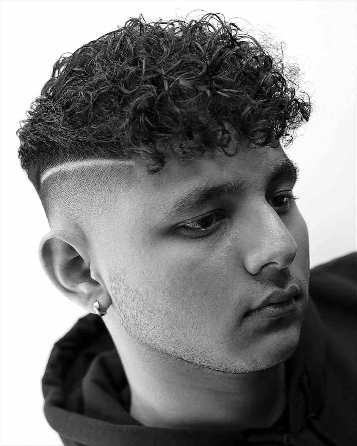 Disconnected Skin Bald Fade with a Curly Top