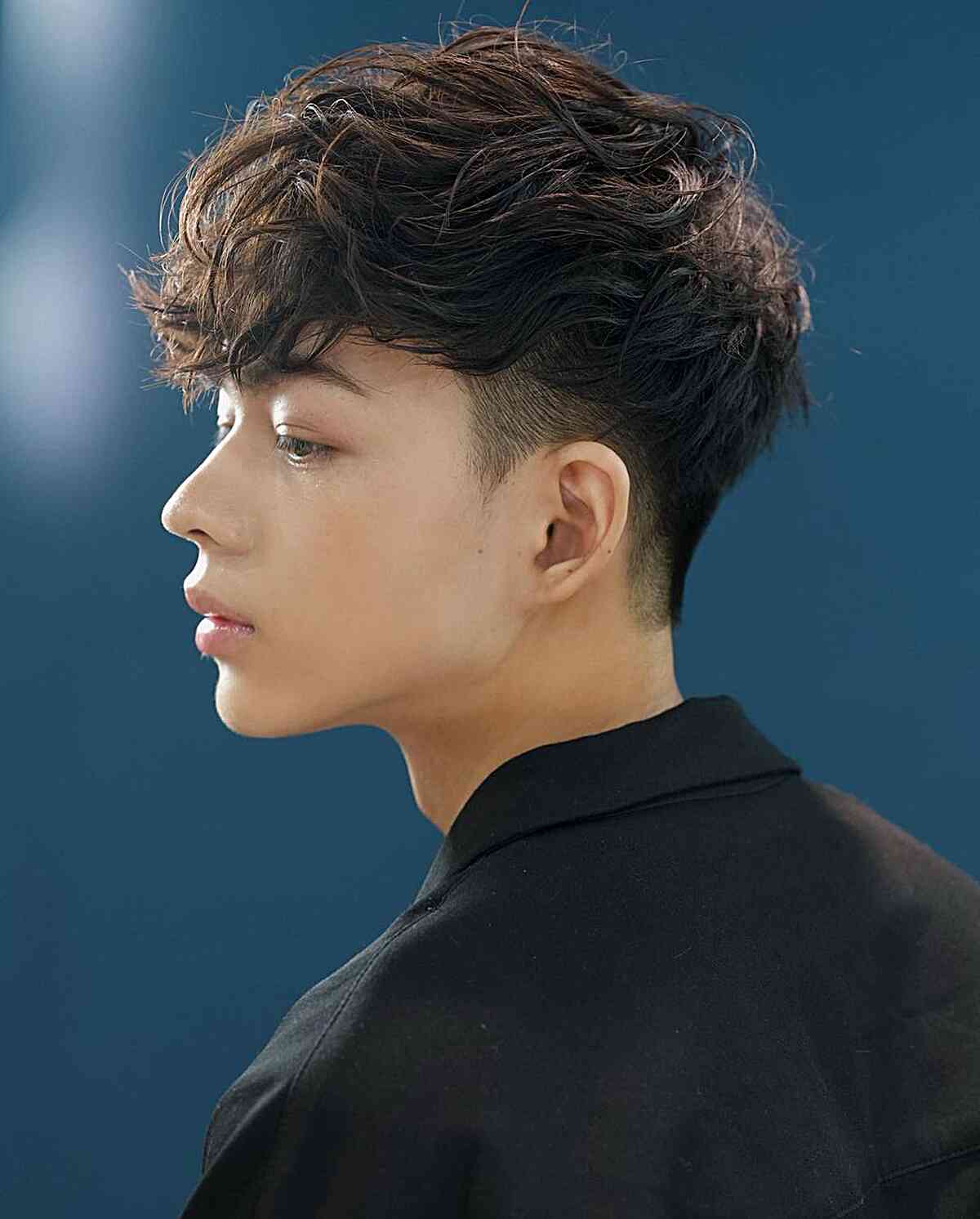 Drop Low Fade with Textured Wavy Bangs for Dudes with Medium Hair