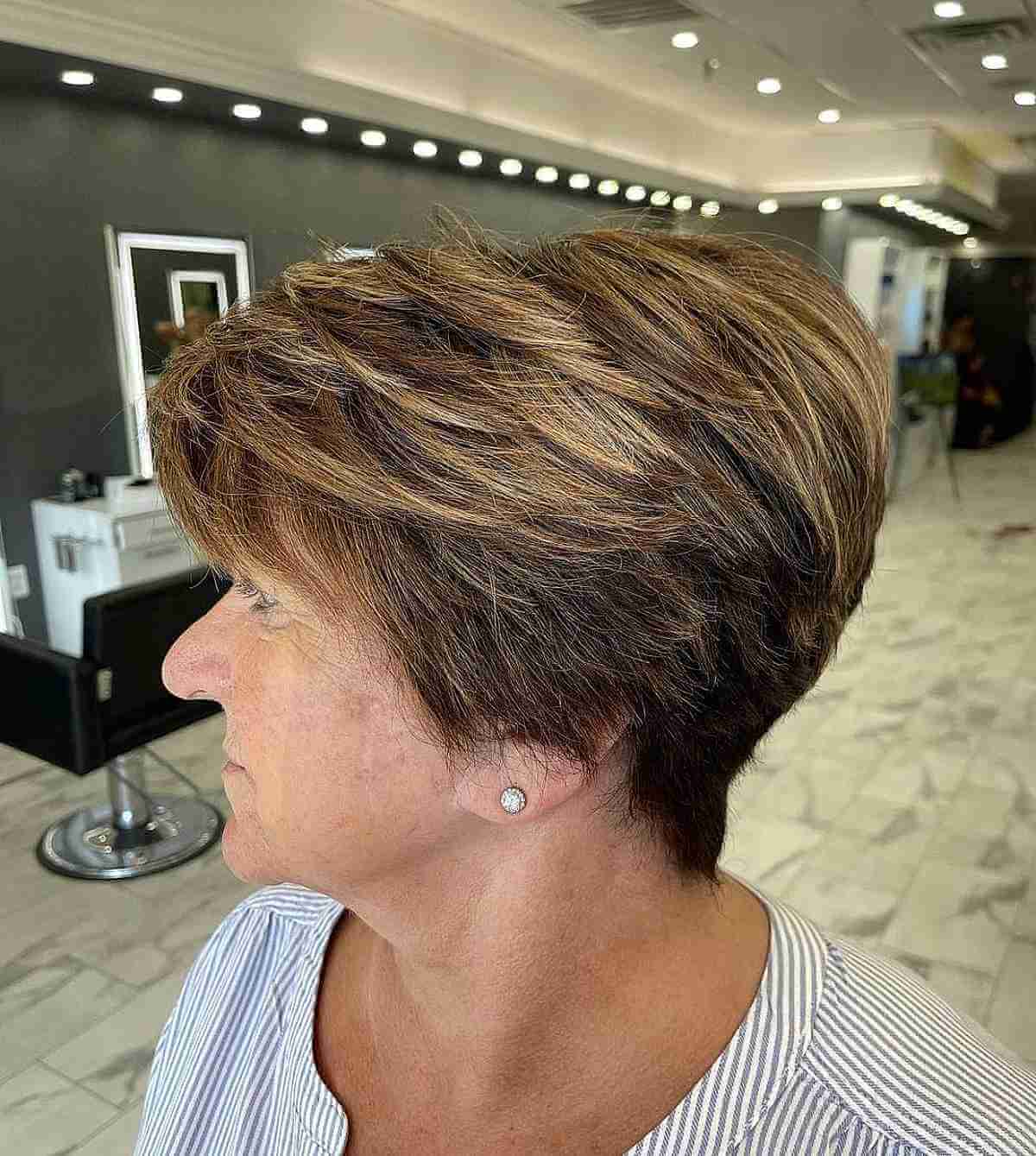 Ear-Length Brunette Haircut with Blonde Highlights for Older Ladies
