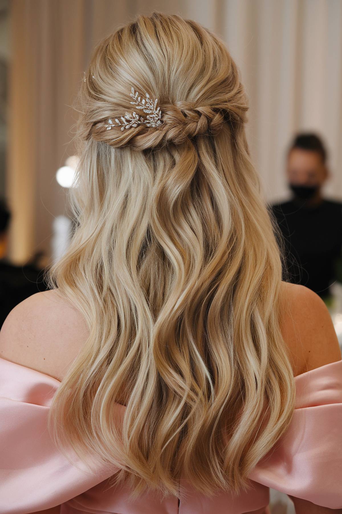 Half-up long wedding hairstyle with braid and crystal pin