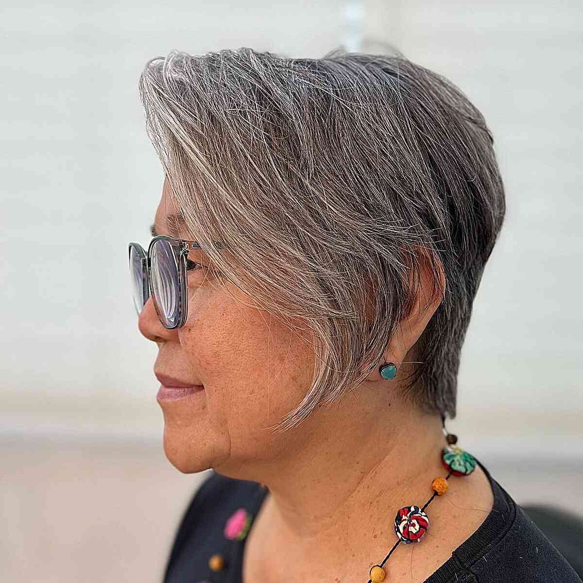 Easy-Maintenance Natural Grey Pixie with Long Bangs for Seniors Aged 50 with Specs