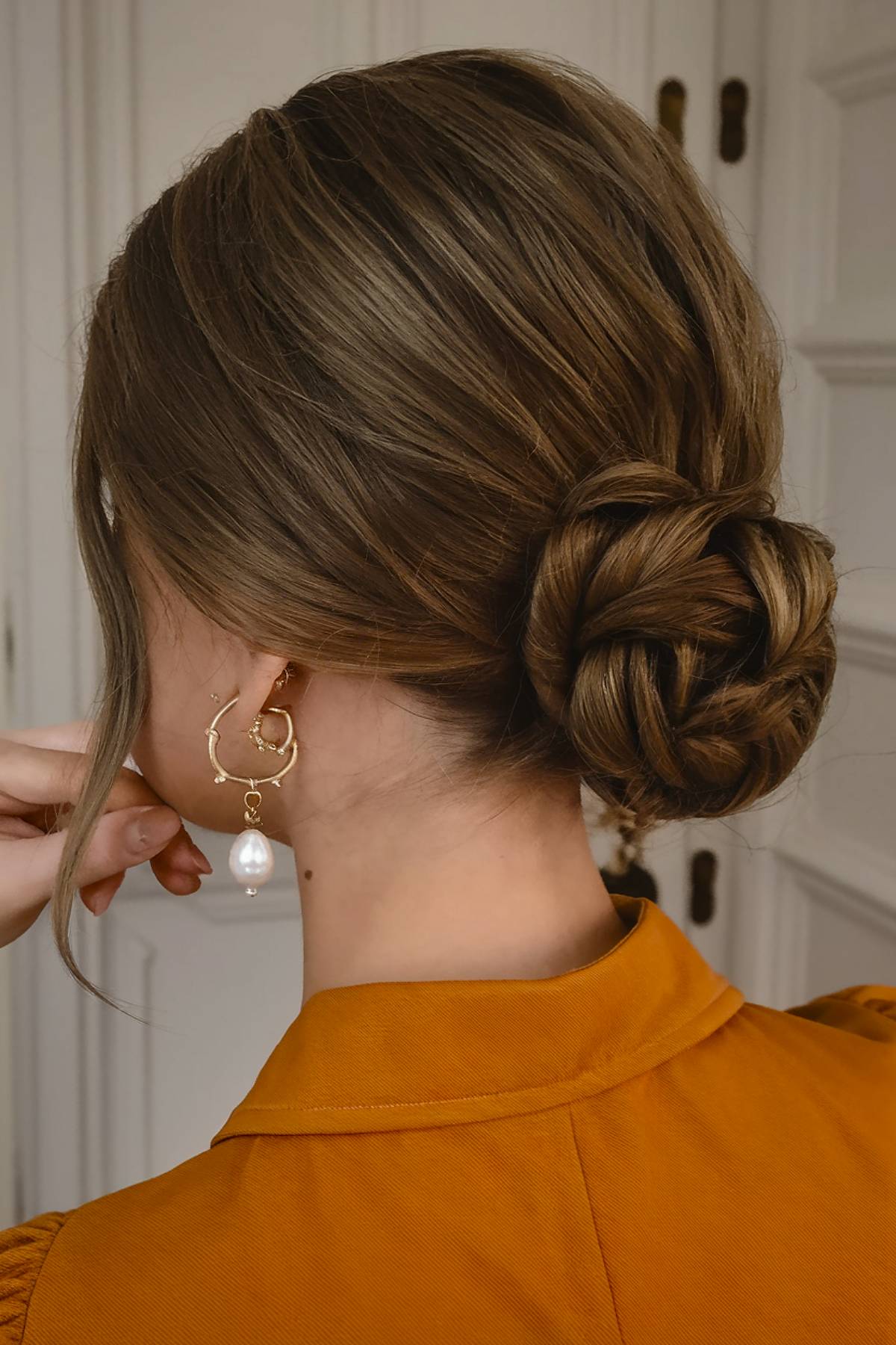 Sleek formal updo with a braided bun and polished styling