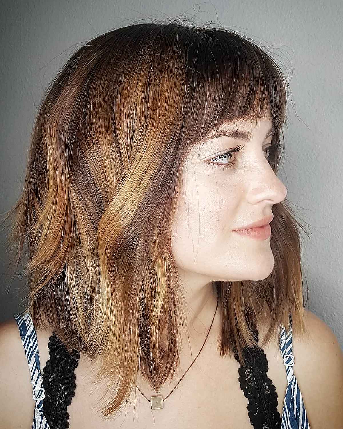 Edgy angled bob with bangs for squared face