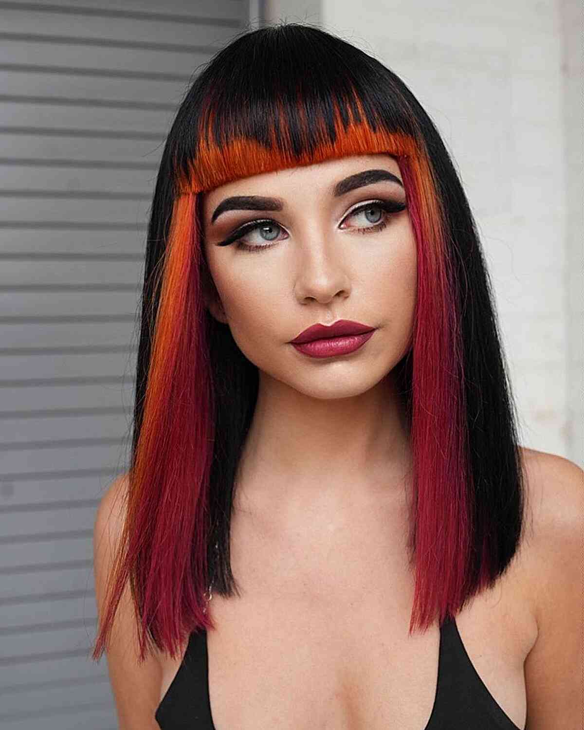 Edgy Black Hair with Red and Orange Money Pieces