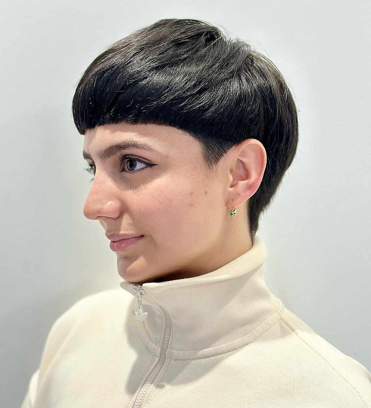 Edgy bowl cut with blunt fringe and undercut on straight, medium-density hair