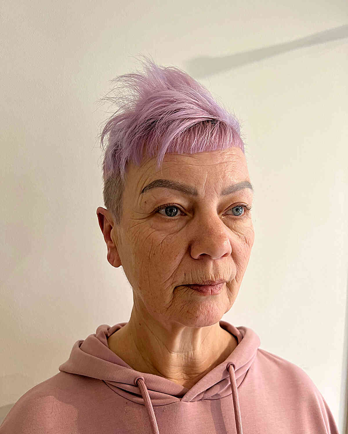 Edgy Pink Choppy Pixie with Volume on Top and Shaved Sides for 70-year-olds