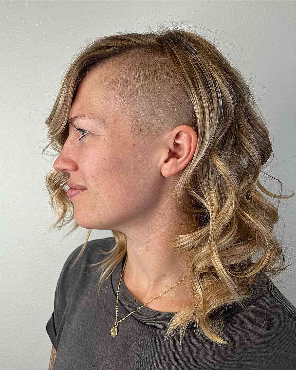 Edgy Undercut with Shaved Sides for Long Hair and women with tousled curls