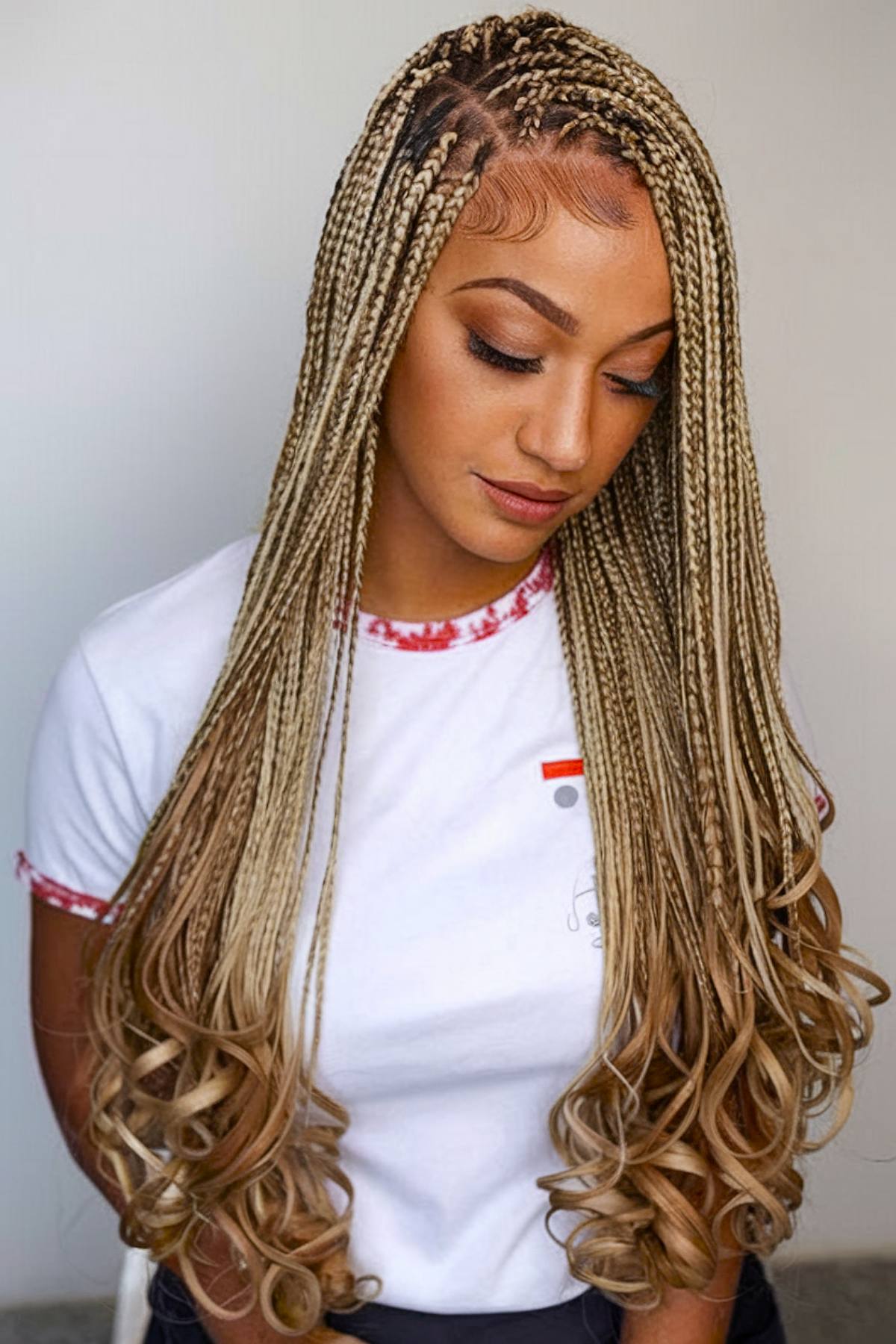 Light blonde box braids with soft French curls