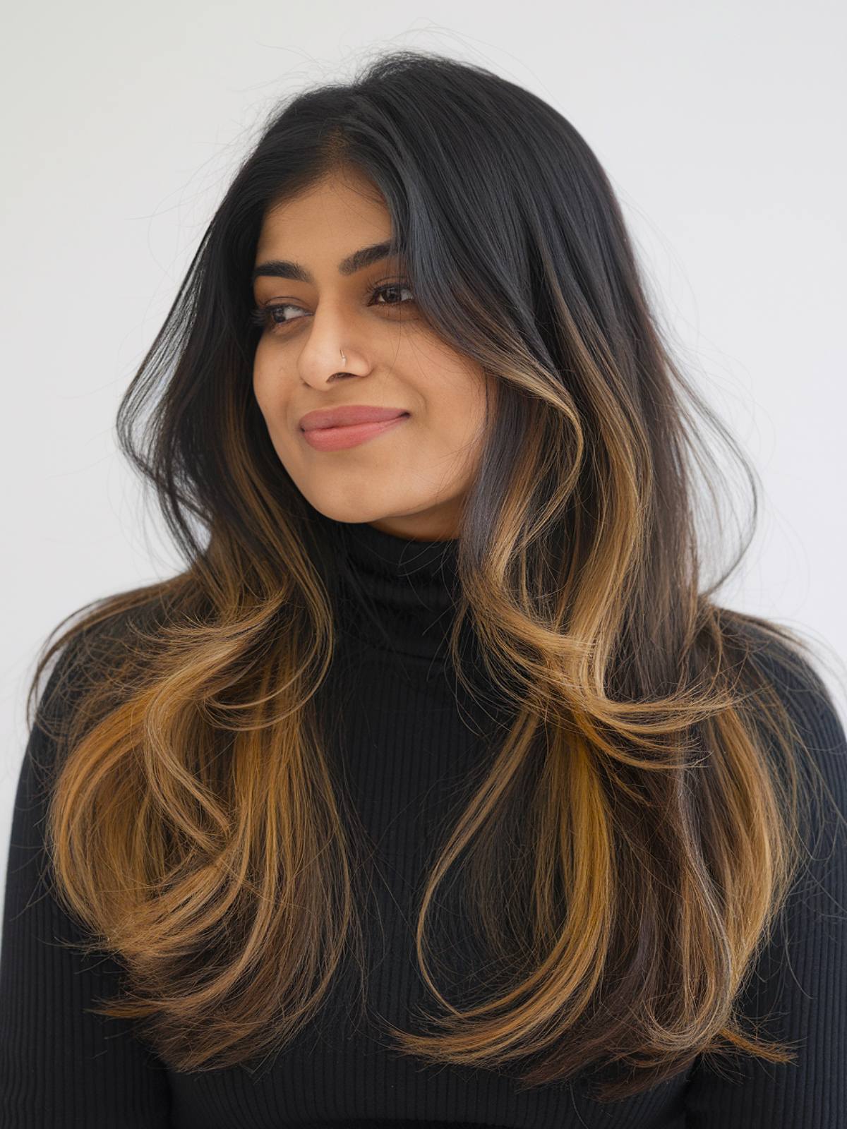 Caramel balayage on long brunette hair for Indian women